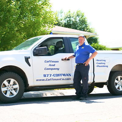 Coffman employee standing in front of company truck